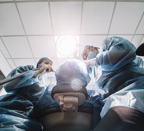 Dentists performing a dental implant surgery