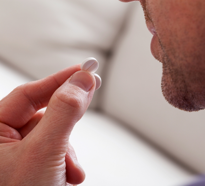 Man holding a white pill