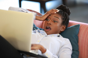 Woman on her laptop is shocked at the therapeutic power of BOTOX